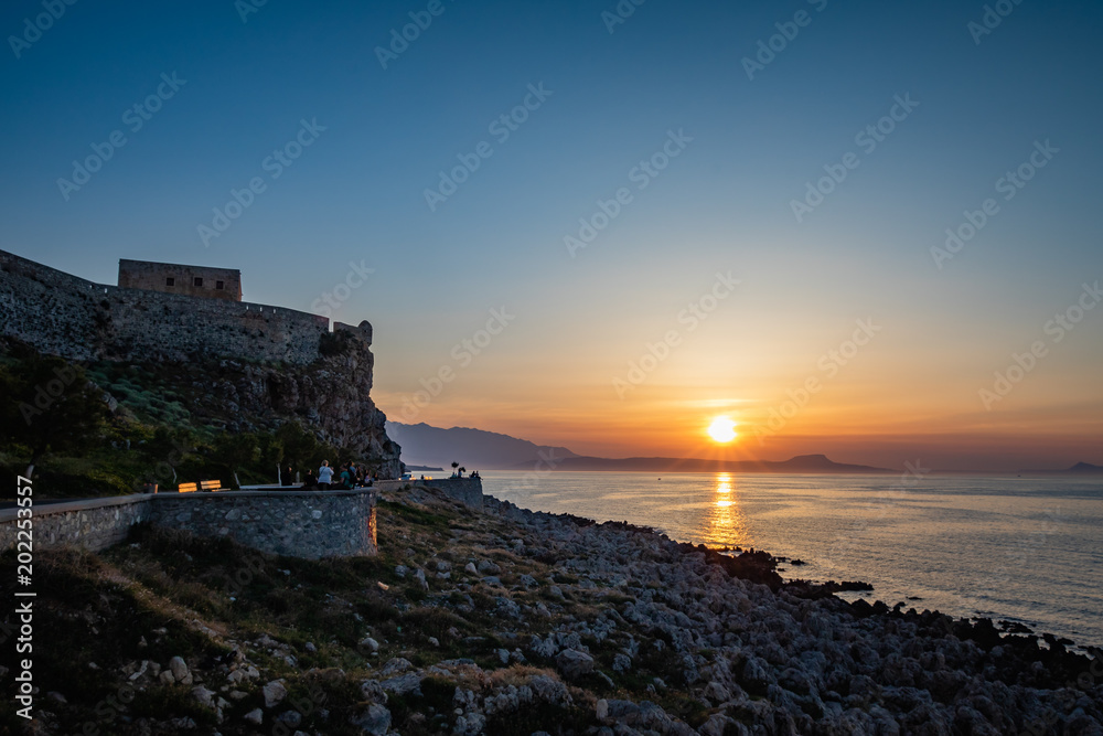 Sunset by the castle. Fortezza of Rethymnon. Sun setting over the Mediterranean. Crete. Greece
