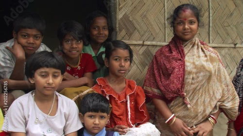 Calcutta children giggling and squirming while waiting for a group portrait photo