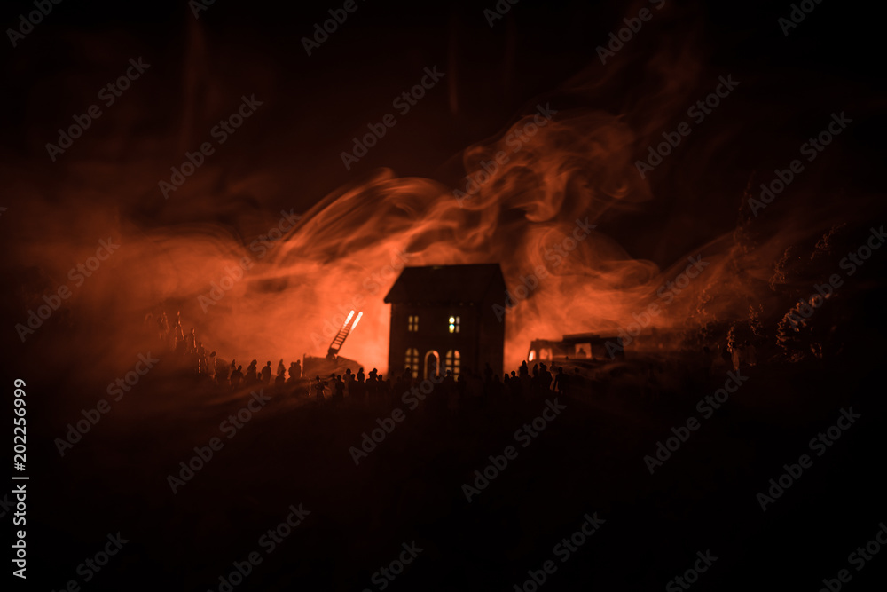 Huge Flame Distracting House on Fire. Fire engine with ladder and fireman trying to save house. Fireman at work. Fire Safety Concept.