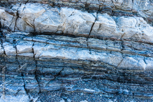 Compressed rock layers formation in various colors and thicknesses, on south central coast of the  Mediterranean island Crete, Greece. Nature and Geological science concept
