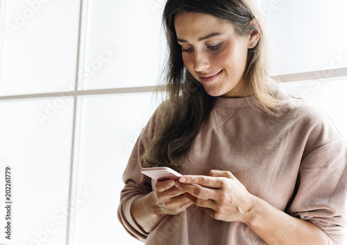 Woman using a smarphone social media conecpt photo