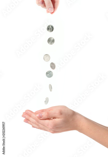 Female hands and falling coins on white background