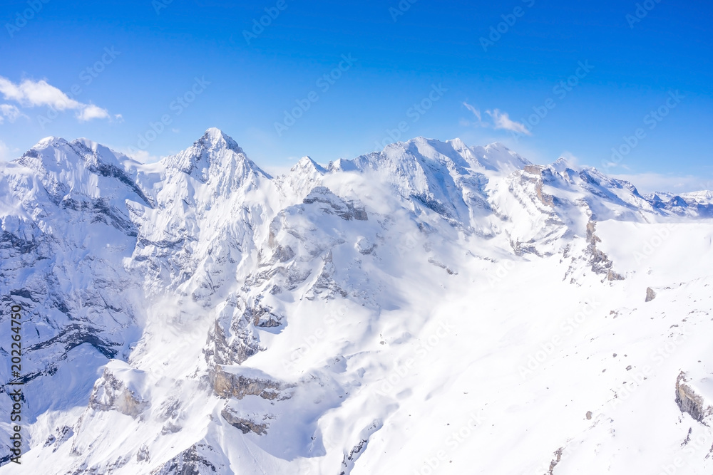 Stunning view of the famous peaks: Eiger, Monch and Jungfrau of Swiss Alps on Bernese Oberland, form top of Schilthorn, Canton of Bern, Switzerland.