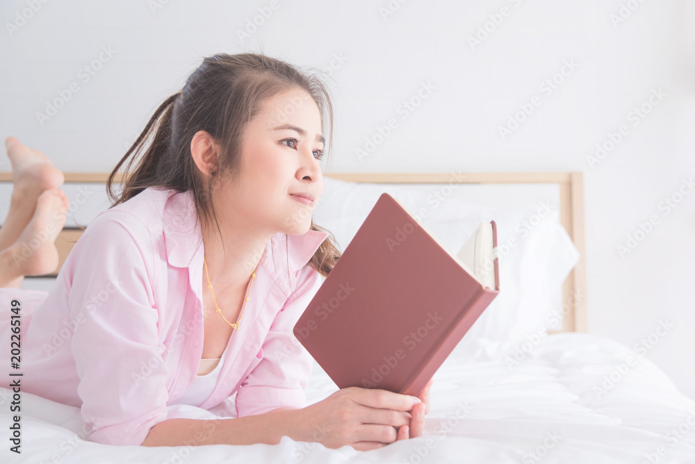 Young asian beautiful woman reading book on bed Young asian beautiful woman reading book on bed