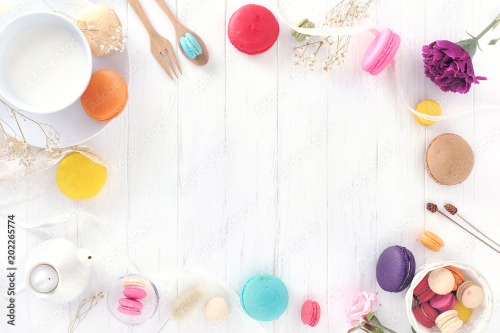 macarons or macaroons and milk on white wooden top view with space for text macarons or macaroons and milk on white wooden top view with space for text