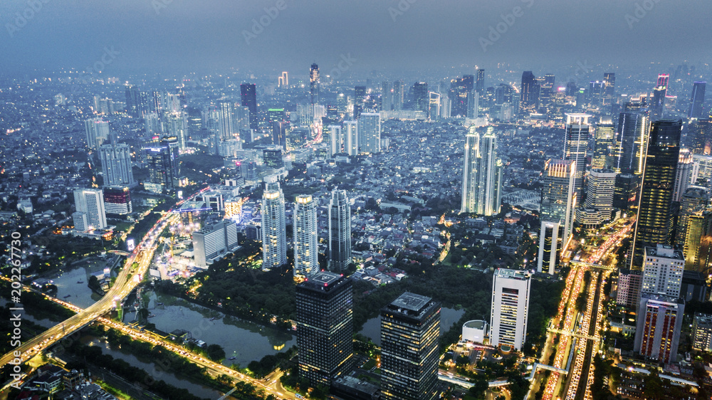 Naklejka premium Drone view of night lights in Jakarta city