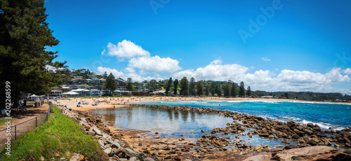 People enjoying a beautiful sunny day at Avoca Beach on the Central Coast, New South Wales, Australia. photo