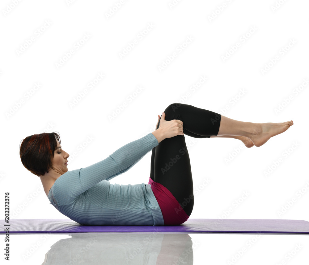 Mother woman exercising doing postnatal workout. Female fitness instructor holds legs in gym and workout exercises Mother woman exercising doing postnatal workout. Female fitness instructor holds legs in gym and workout exercises