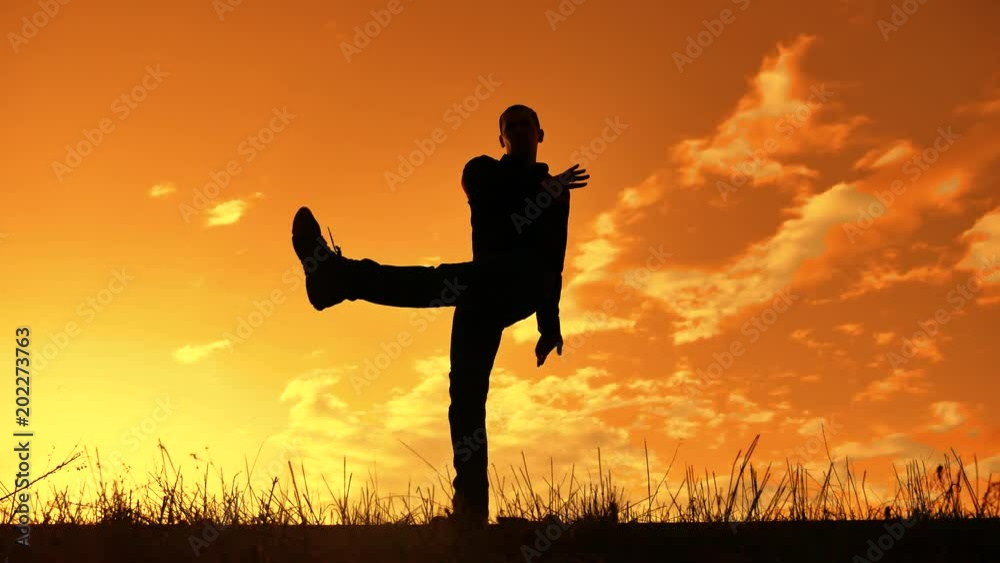 silhouette of a man funny dancing at sunset nature sunlight. funny man laughter dance lifestyle entertainment crazy feels joy dance silhouette of a man funny dancing at sunset nature sunlight. funny man laughter dance lifestyle entertainment crazy feels joy dance