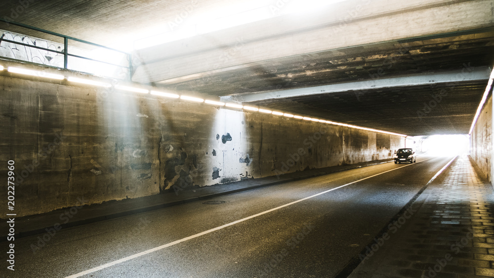 City tunnel with dramatic light with one car going