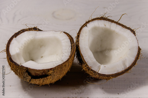 Fresh ripe coconut on white wooden table