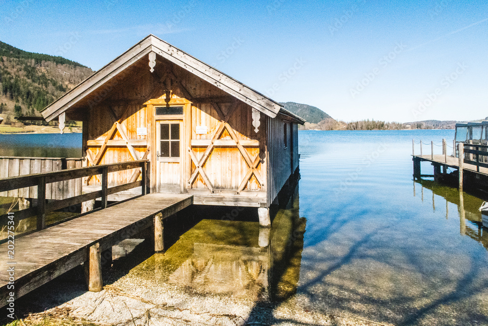 Old wooden house resting over a lake in the morning Old wooden house resting over a lake in the morning