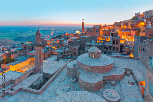 Mardin old town at dusk. Historical beige colored limestone rock buildings