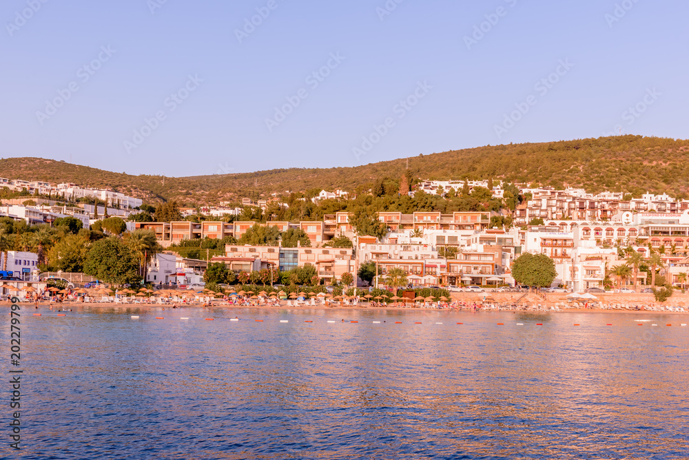 Typical Aegean architecture houses with white color and beach