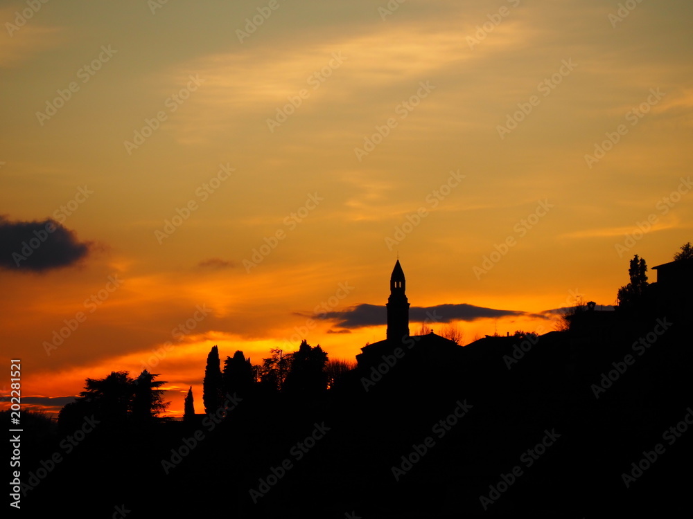 Fiery sunset from the old city of Bergamo to the hills surrounding the town