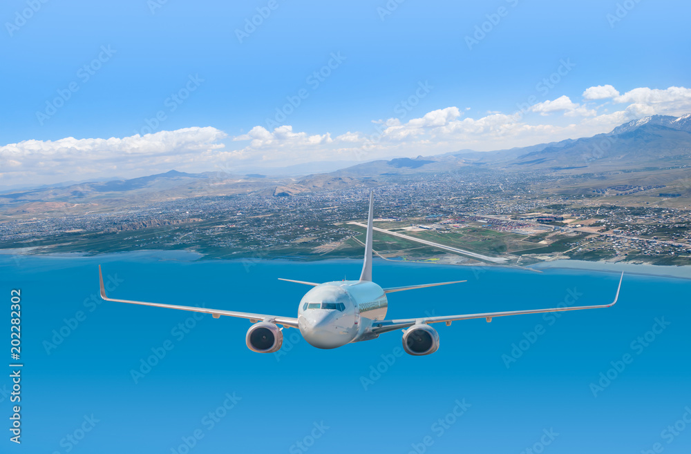 Fototapeta White passenger airplane in the clouds. travel by air transport