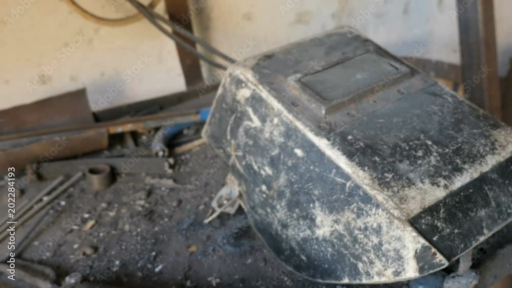 The panoramic view of workbench with old welding mask and welder tools. Manufacturing, workshop
The panoramic view of workbench with old welding mask and welder tools. Manufacturing, workshop
