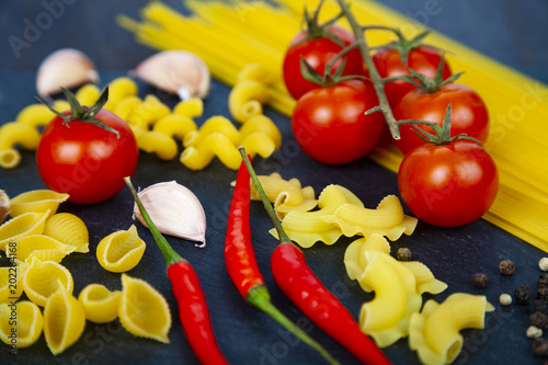 Different pasta on a dark background.