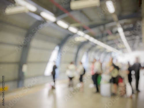 blurred image of business people, passenger or city human lifestyle waiting for train coming at airport rail link, subway station, transport in rush hour. transportation concept