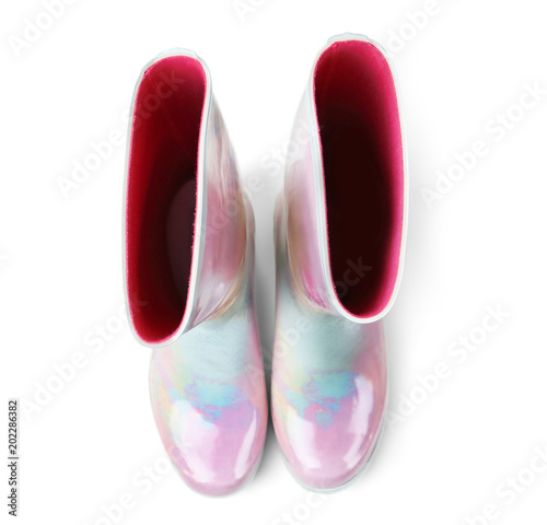 Pair of gumboots on white background, top view. Female shoes