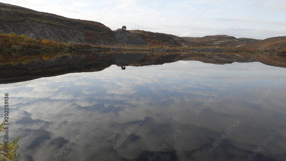 Clouds reflected in the clear water of the lake on the Kola Peninsula