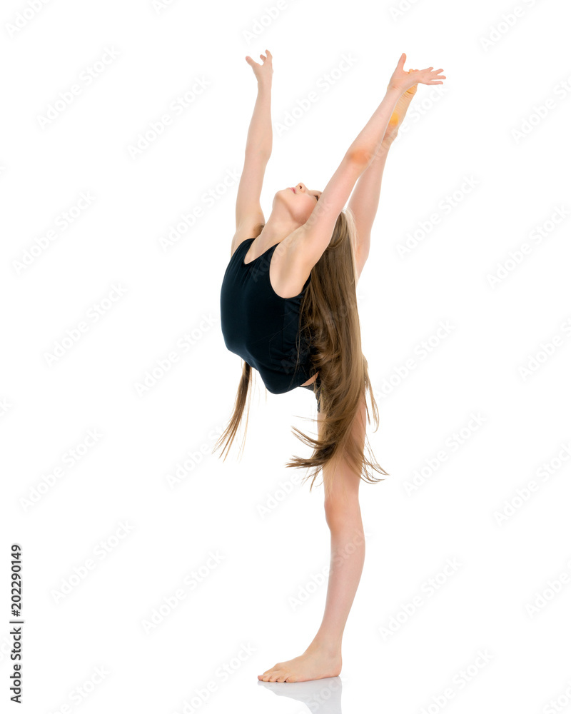 Fototapeta premium The gymnast balances on one leg.