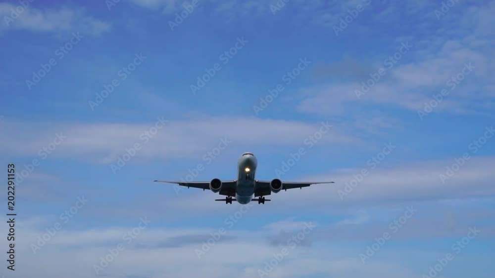 Airplane flying under blue sky and white cloud in Phuket, Thailand Airplane flying under blue sky and white cloud in Phuket, Thailand