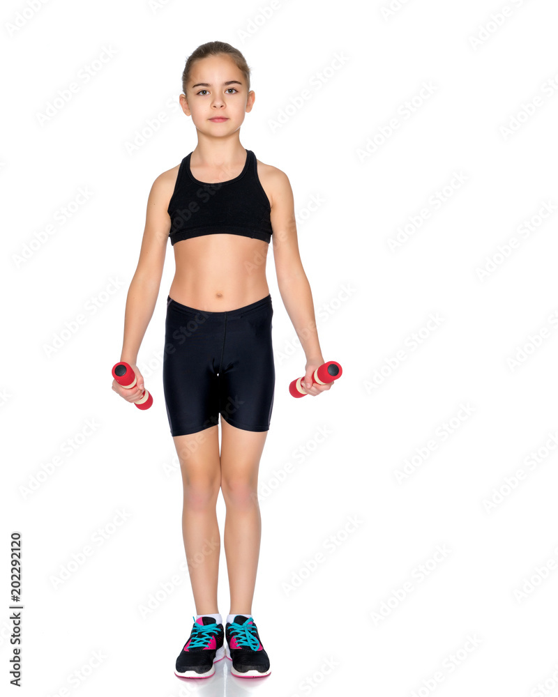 Little girl doing exercises with dumbbells. Little girl doing exercises with dumbbells.
