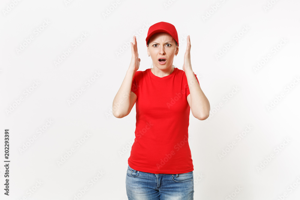 Delivery woman in red uniform isolated on white background. Professional shocked female in cap, t-shirt, jeans working as courier or dealer, holding hands near face gesture. Copy space, advertisement. Delivery woman in red uniform isolated on white background. Professional shocked female in cap, t-shirt, jeans working as courier or dealer, holding hands near face gesture. Copy space, advertisement.