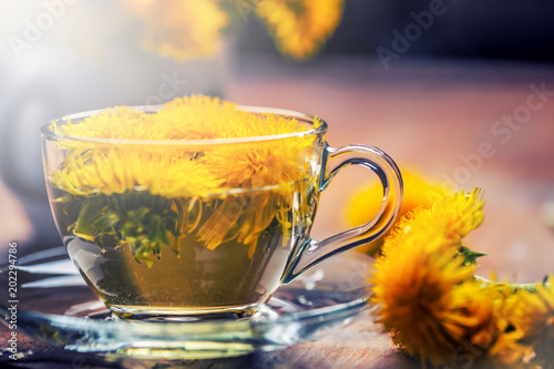 Cup of dandelion tea on rustic wooden table