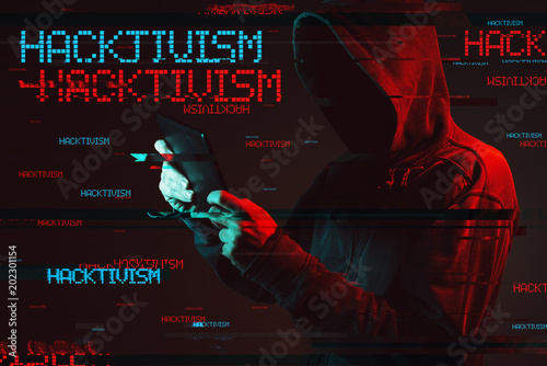 Hacktivism concept with faceless hooded male person photo