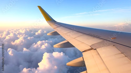 Airplane flight. Wing of an airplane flying above the clouds. View from the window of the plane. Aircraft. Traveling. 4K UHD video footage. 3840X2160