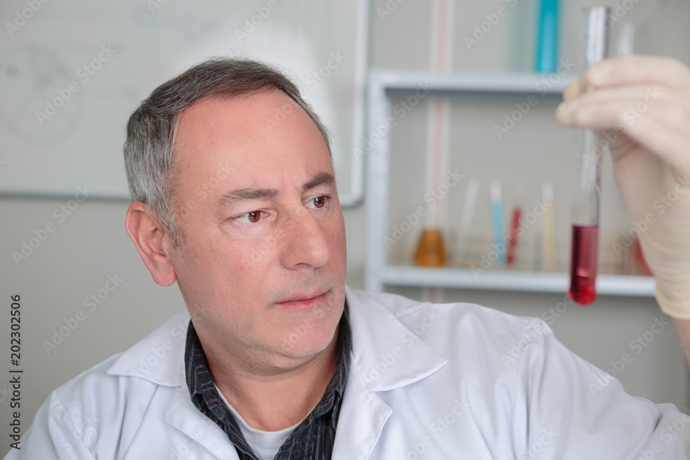 male chemist testing in a lab male chemist testing in a lab