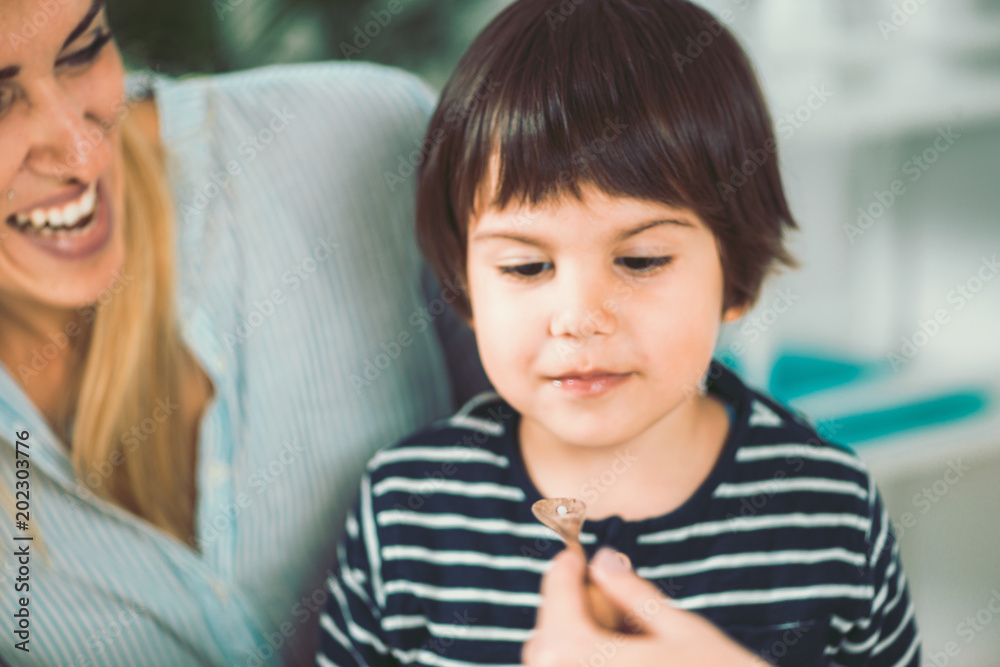 Homeopathy. Mother and little boy visiting a homeopath Homeopathy. Mother and little boy visiting a homeopath