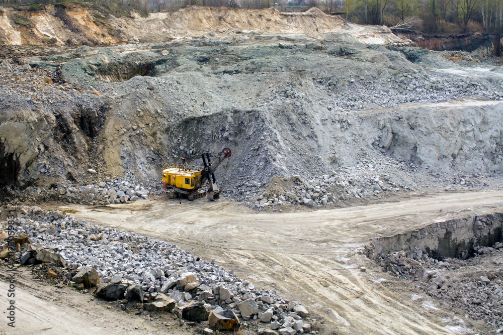 Excavator works quarrying uranium mining. heavy machinery Excavator works quarrying uranium mining. heavy machinery