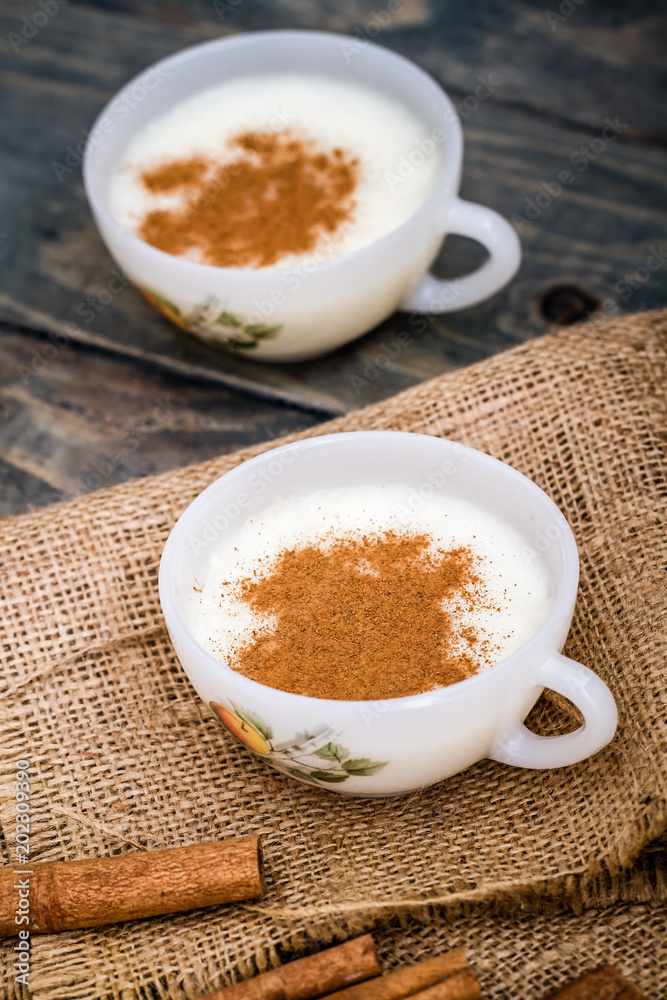 Delicious Turkish Hot Winter Drink, Sahlep Cups on Wooden Background Delicious Turkish Hot Winter Drink, Sahlep Cups on Wooden Background
