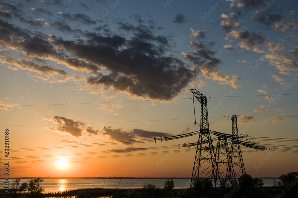 power line support 750 kW at sunset