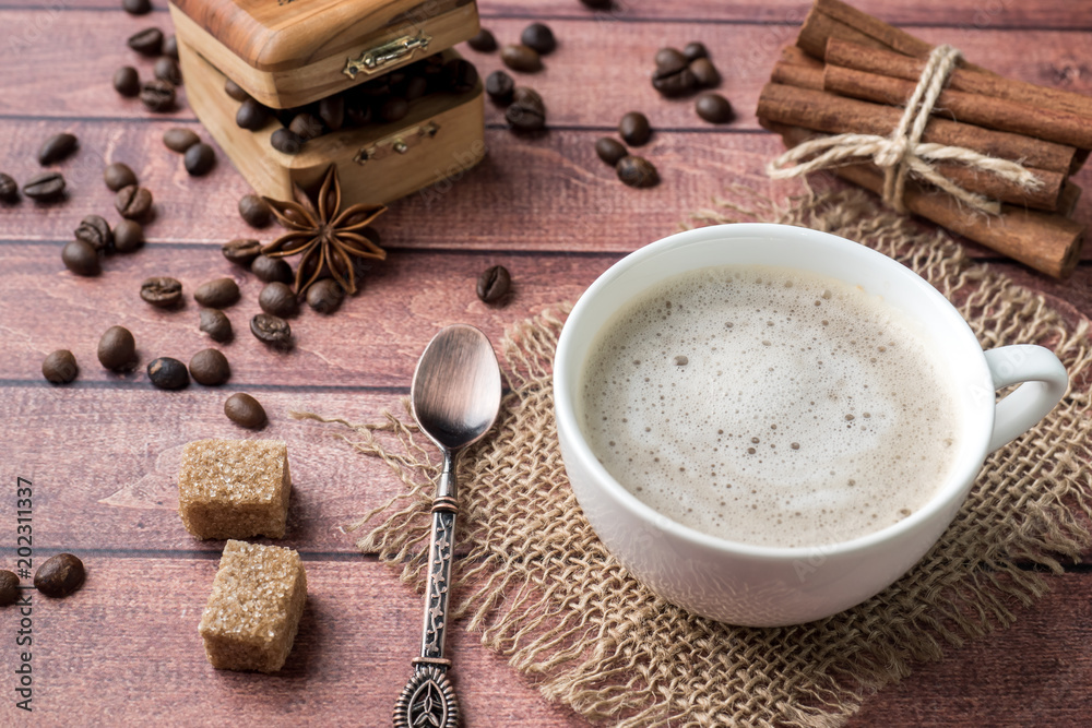White coffee Cup and saucer with milk foam and cane sugar cinnamon Anise Coffee beans White coffee Cup and saucer with milk foam and cane sugar cinnamon Anise Coffee beans