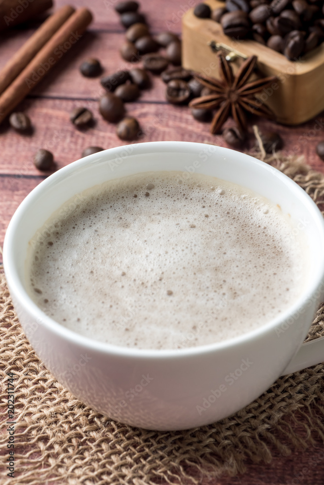 White coffee Cup and saucer with milk foam and cane sugar cinnamon Anise Coffee beans White coffee Cup and saucer with milk foam and cane sugar cinnamon Anise Coffee beans