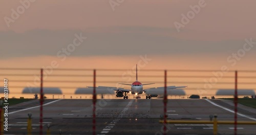 Commercial airplane taking off runway, super tele zoom lens photo