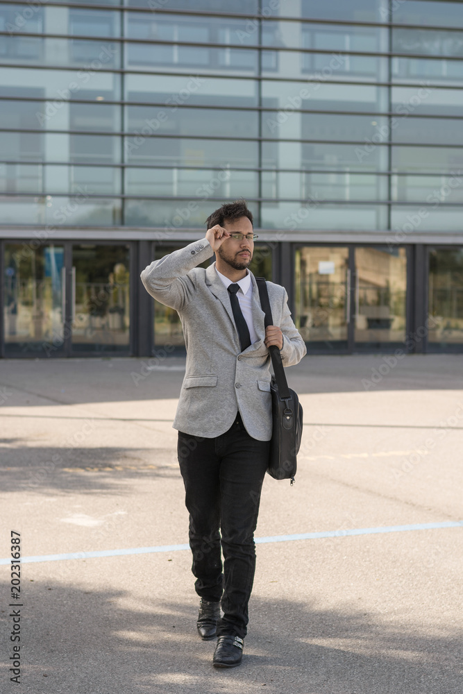 Latin businessman, leaving work from his office