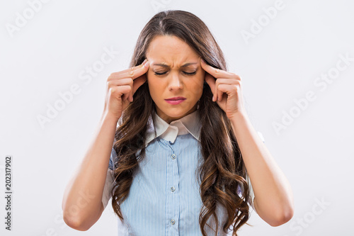 Desperate businesswoman having strong headache.