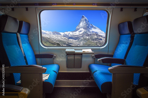 Panoramic view of Matterhorn peak in Zermatt, Switzerland viewed from the train window. Lighting effect on the window.