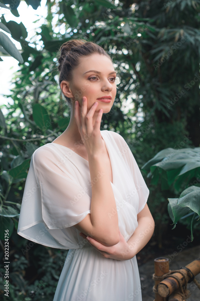 tender bride in white dress posing in tropical garden tender bride in white dress posing in tropical garden