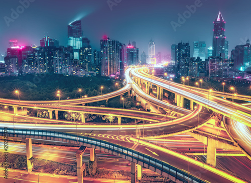 View over the famous highway intersection in Shanghai, China. Modern architecture of a big city. Scenic nighttime skyline.