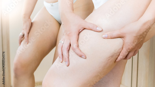Closeup image of young woman in panties with cellulite