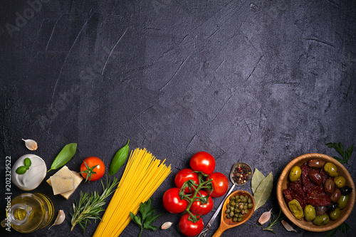 Selection of healthy food. Italian food background with spaghetti, mozzarella parmesan cheese, olives, tomatoes and rosemary. Vegetarian food banner. overhead, horizontal