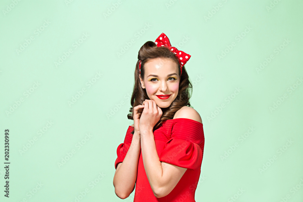 Beautiful young woman with pinup make-up and hairstyle. Studio shot on white background Beautiful young woman with pinup make-up and hairstyle. Studio shot on white background