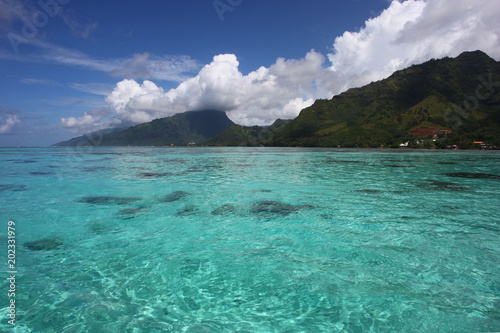 Tropical coast of Moorea with turquoise water, beautiful islands & mountains, French Polynesia, South Pacific.