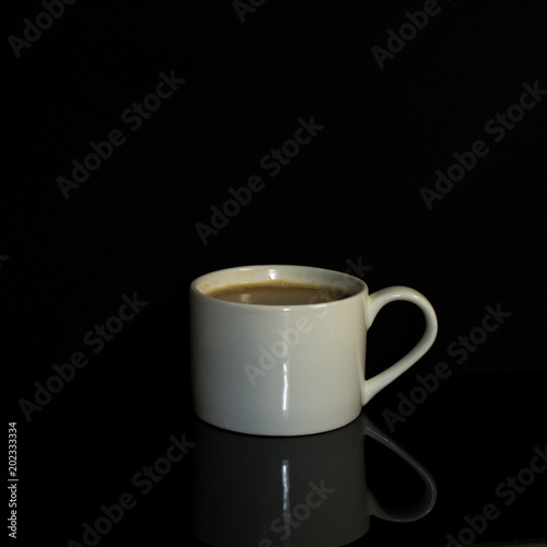 a cup of coffee on the black background